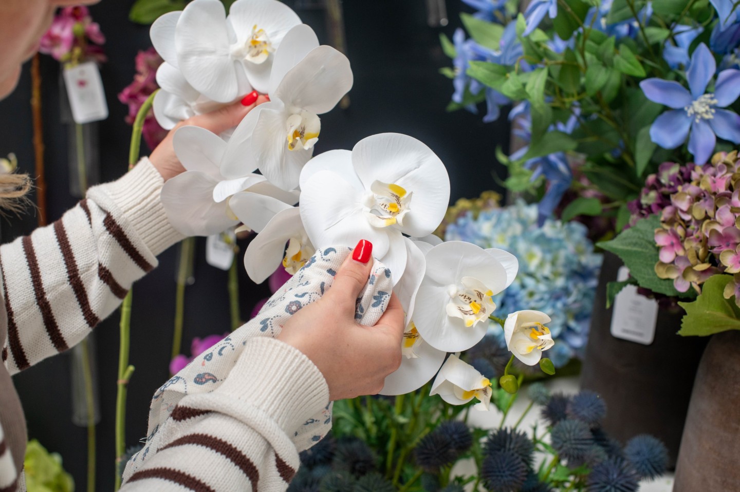 a person cleaning artificial flowers with a soft cloth